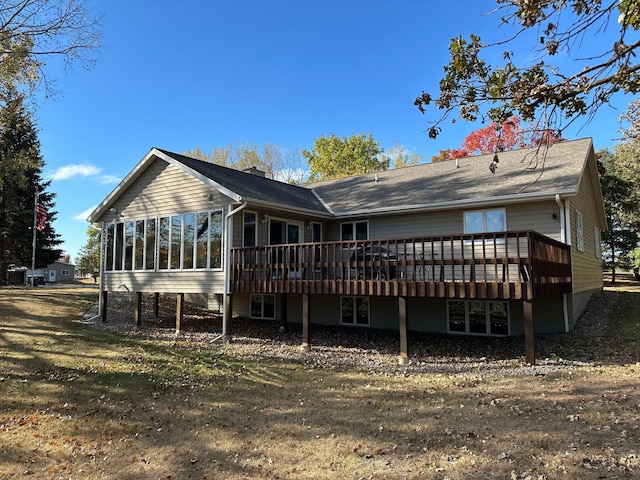 rear view of house featuring a deck and a sunroom