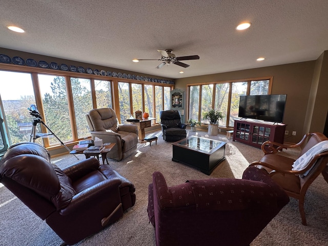 carpeted living room featuring a ceiling fan, recessed lighting, and a textured ceiling