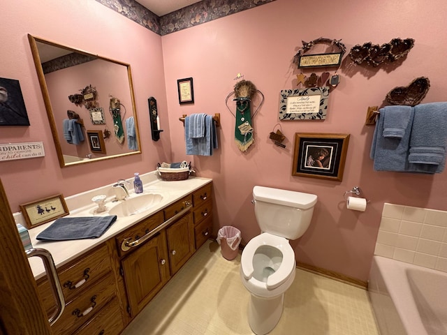 full bath featuring vanity, toilet, a bath, and baseboards