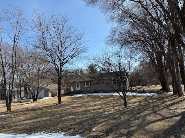 exterior space featuring a garage and a lawn