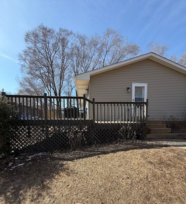 view of property exterior with a deck