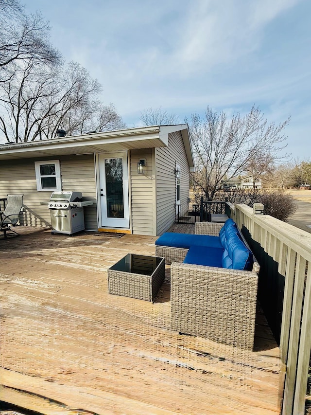 wooden deck with grilling area and an outdoor living space