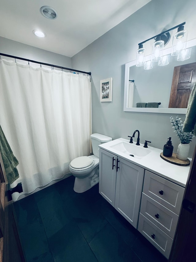 bathroom featuring visible vents, toilet, and vanity