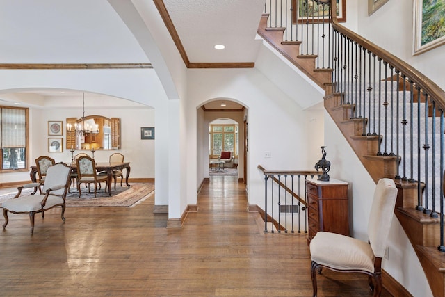 entryway featuring recessed lighting, baseboards, a high ceiling, and wood finished floors