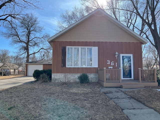 view of front of home featuring a garage, a porch, and an outdoor structure