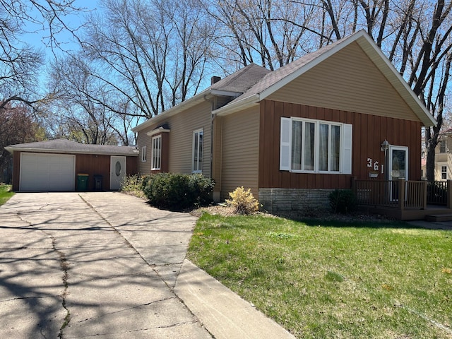 361 Hollett St, Tracy, MN 56175 - view of front facade featuring a front lawn, concrete driveway, a detached garage, and an outdoor structure