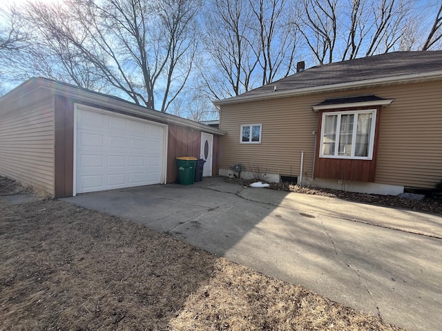 361 Hollett St, Tracy, MN 56175 - view of home's exterior featuring driveway, an attached garage, and an outdoor structure