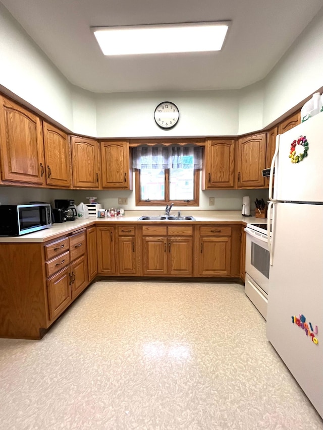 361 Hollett St, Tracy, MN 56175 - kitchen featuring white appliances, brown cabinets, light countertops, and light floors