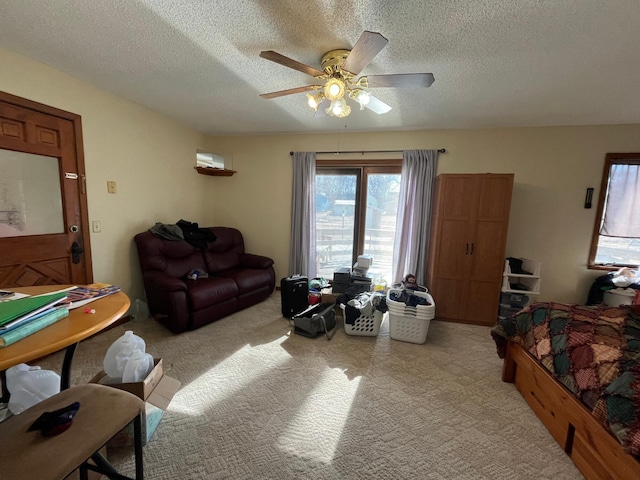 361 Hollett St, Tracy, MN 56175 - living area with light colored carpet, a textured ceiling, and ceiling fan