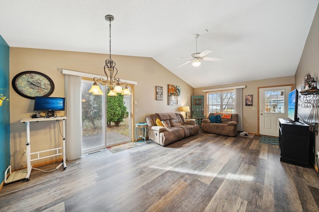 living room with ceiling fan with notable chandelier, wood finished floors, and vaulted ceiling