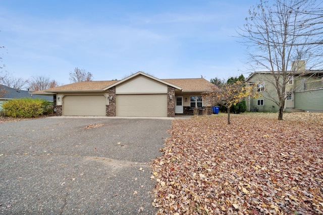 view of front of home featuring brick siding, a shingled roof, aphalt driveway, and a garage