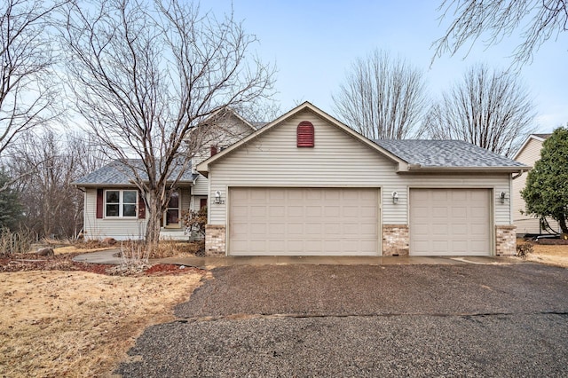 ranch-style house with a garage, brick siding, and a shingled roof