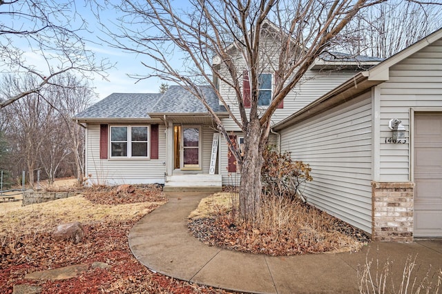 view of front of house featuring roof with shingles