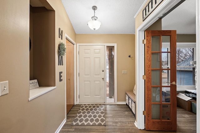 entrance foyer featuring dark wood-style floors and baseboards