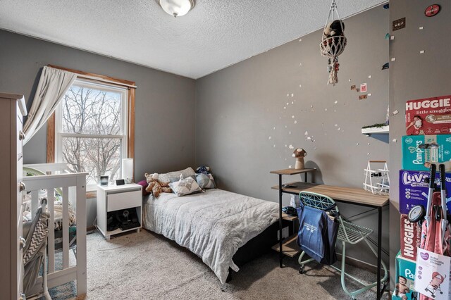 bedroom featuring carpet and a textured ceiling