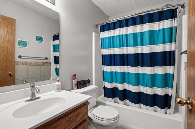 full bathroom featuring vanity, toilet, shower / bath combo, and a textured ceiling