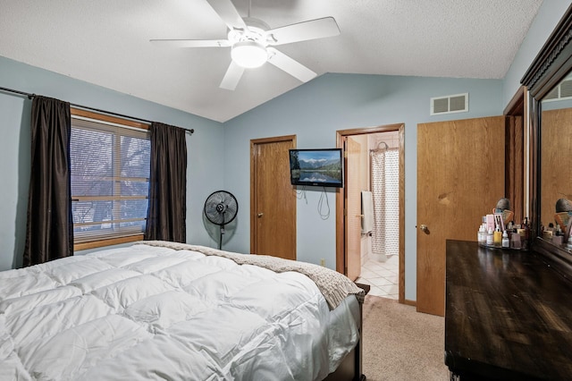 bedroom with visible vents, carpet floors, ceiling fan, vaulted ceiling, and a textured ceiling