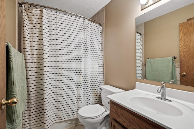 bathroom featuring toilet, a textured ceiling, and vanity