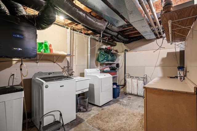 clothes washing area featuring laundry area and washing machine and clothes dryer