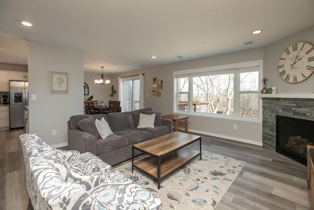 living area featuring recessed lighting, a fireplace, baseboards, and dark wood-style flooring