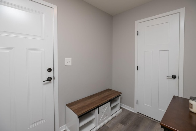 mudroom with dark wood-type flooring and baseboards