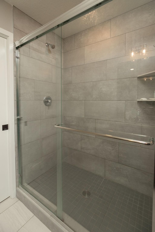 full bath featuring tile patterned flooring and a stall shower