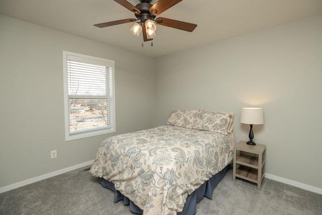 carpeted bedroom featuring a ceiling fan and baseboards