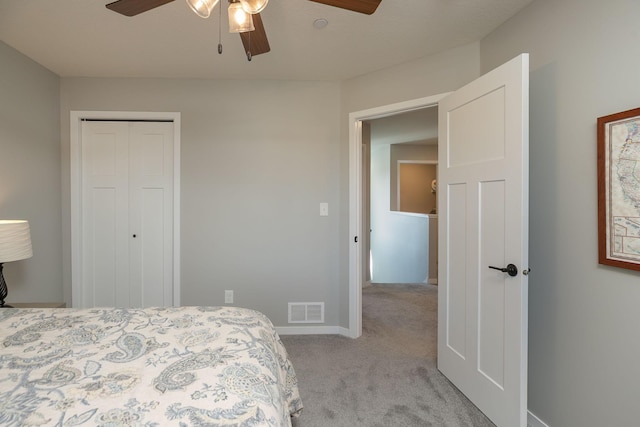 bedroom with visible vents, light carpet, a ceiling fan, a closet, and baseboards