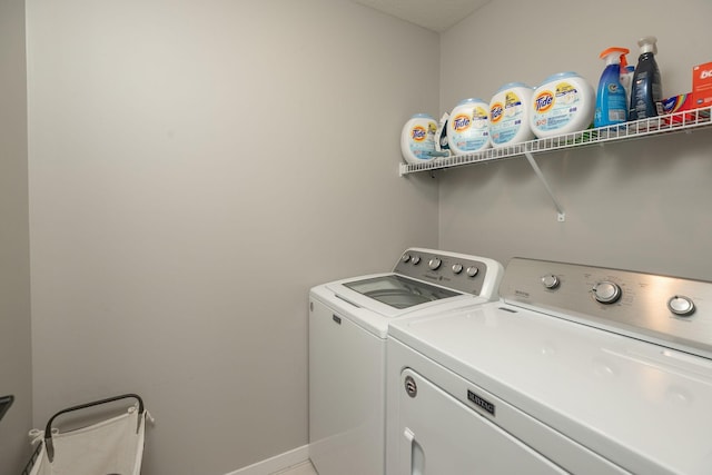 laundry area featuring laundry area, washing machine and dryer, and baseboards