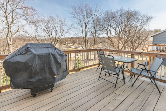 deck with area for grilling and outdoor dining area