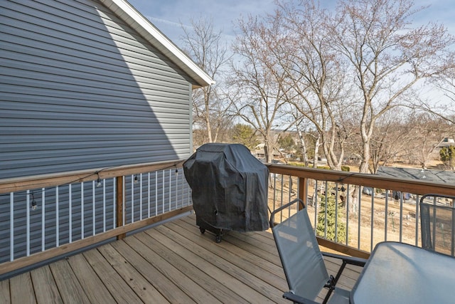 wooden deck featuring a grill