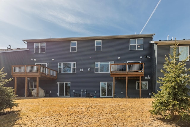 rear view of house featuring a wooden deck