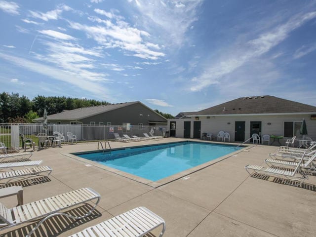 community pool featuring a patio area and fence