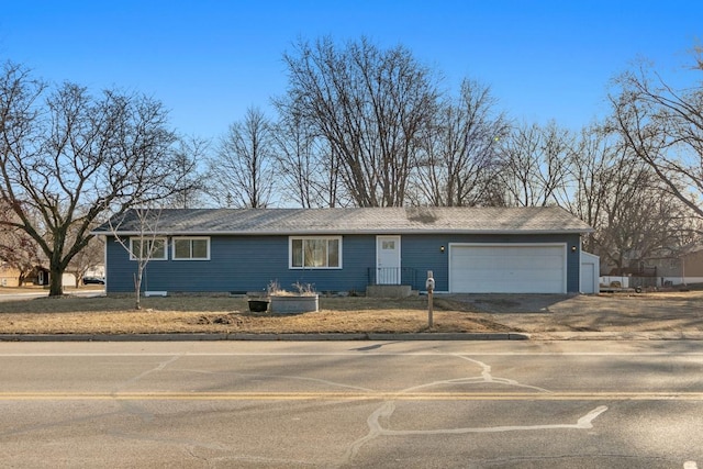 single story home with driveway and a garage