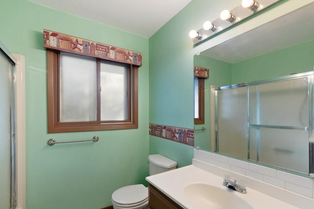 bathroom featuring an enclosed shower, toilet, and vanity