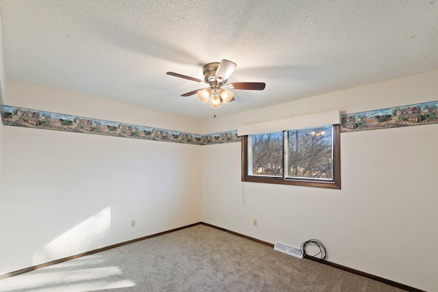 empty room with visible vents, light carpet, a textured ceiling, and baseboards