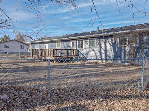 view of front of home featuring a deck and fence