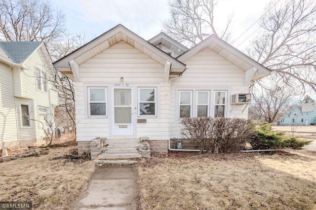 bungalow with a wall unit AC and entry steps