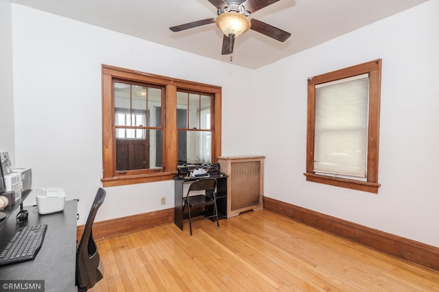 office with baseboards, a ceiling fan, and light wood finished floors