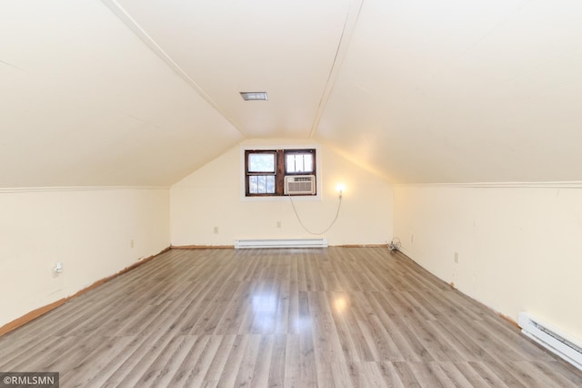 bonus room with vaulted ceiling, cooling unit, a baseboard heating unit, and wood finished floors