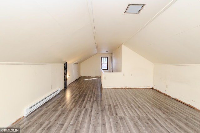 bonus room with a baseboard radiator, lofted ceiling, and wood finished floors