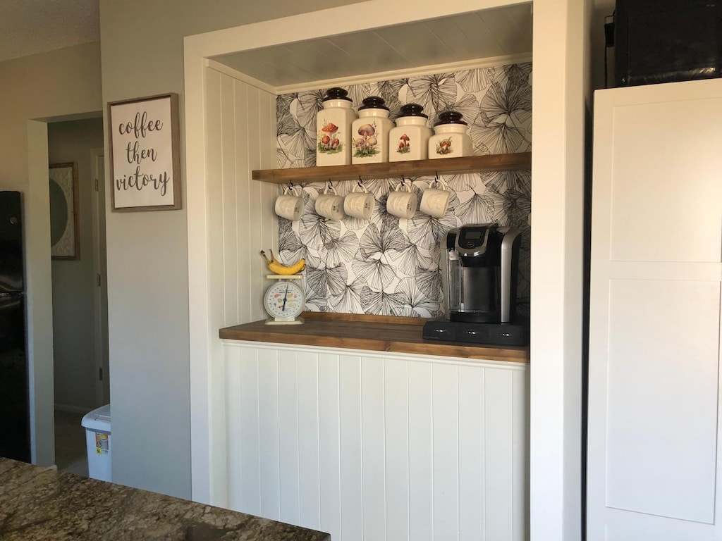 bar featuring freestanding refrigerator