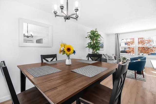 dining room featuring an inviting chandelier and light wood-style floors