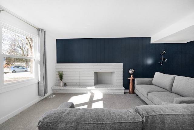 living area featuring carpet flooring, a fireplace, and baseboards