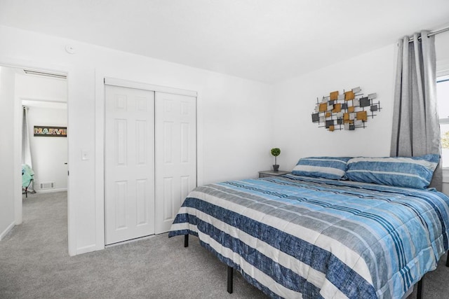 bedroom featuring visible vents, carpet, and a closet