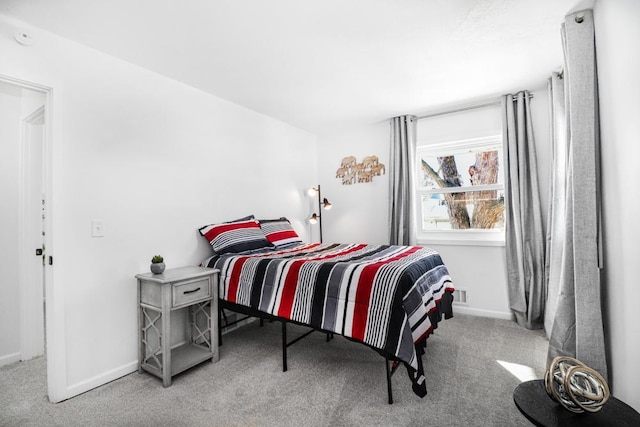 bedroom featuring baseboards and carpet floors