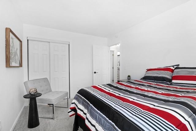 bedroom featuring a closet, baseboards, and carpet