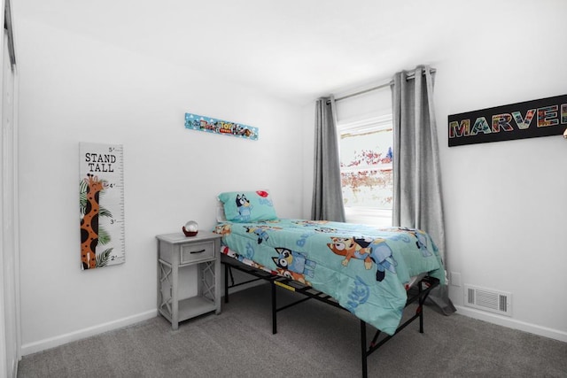 carpeted bedroom featuring visible vents and baseboards