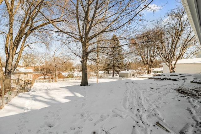 yard layered in snow with a garage