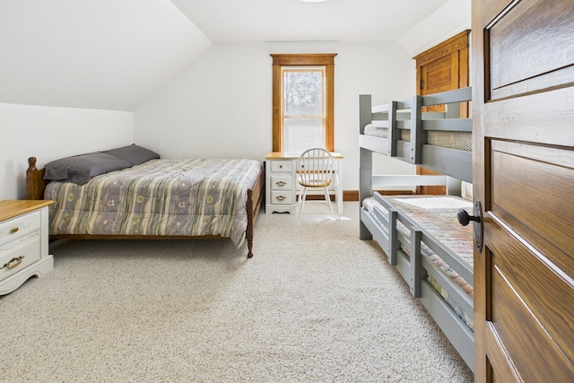 bedroom featuring vaulted ceiling and light colored carpet